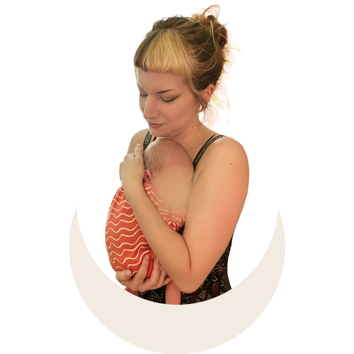 A photo of Carli holding her birth doula client baby with their face censored